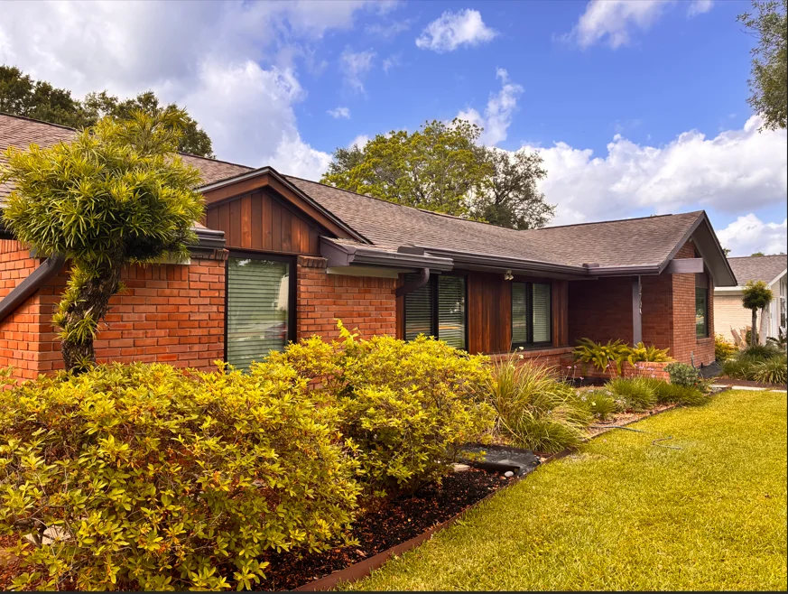 Brick and cedar exterior renovation by Father And Son Remodeling Houston
